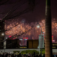 Watching the show from behind a construction site fence